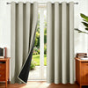 A pair of floor-length beige thermal insulated blackout curtains hanging in a doorway.