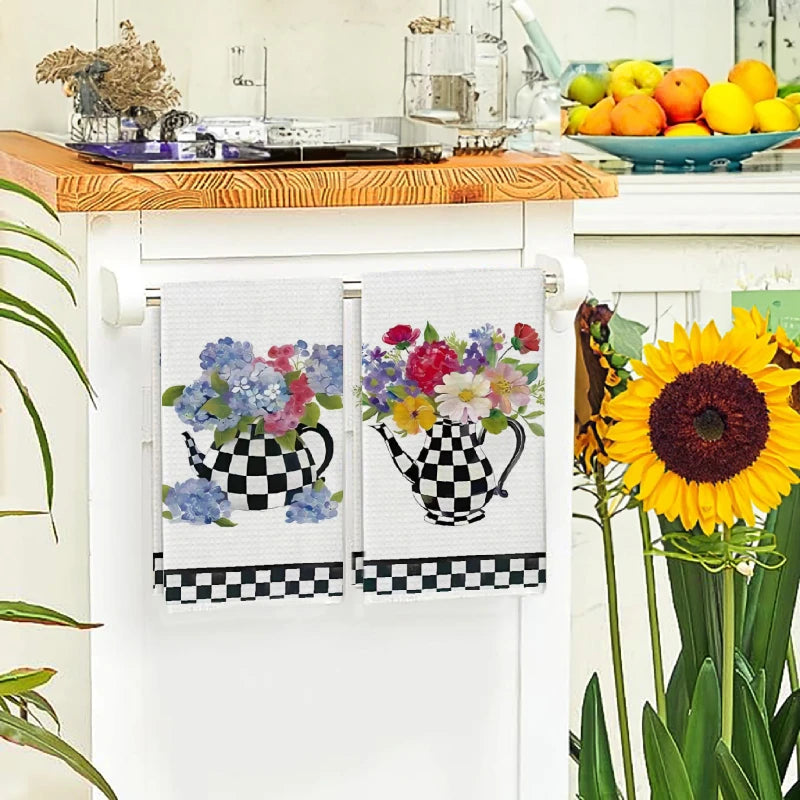 A set of checkered kitchen towels featuring colorful floral designs on white and black patterns.