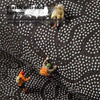 A close-up view of a black non-slip mat with white dots, showing an anti-skid bottom feature.