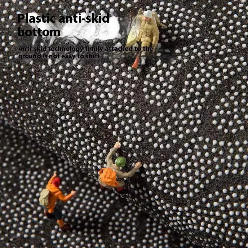 A close-up view of a black non-slip mat with white dots, showing an anti-skid bottom feature.