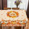 Fall harvest tablecloth featuring orange pumpkins, maple leaves, and autumn foliage on a beige background.