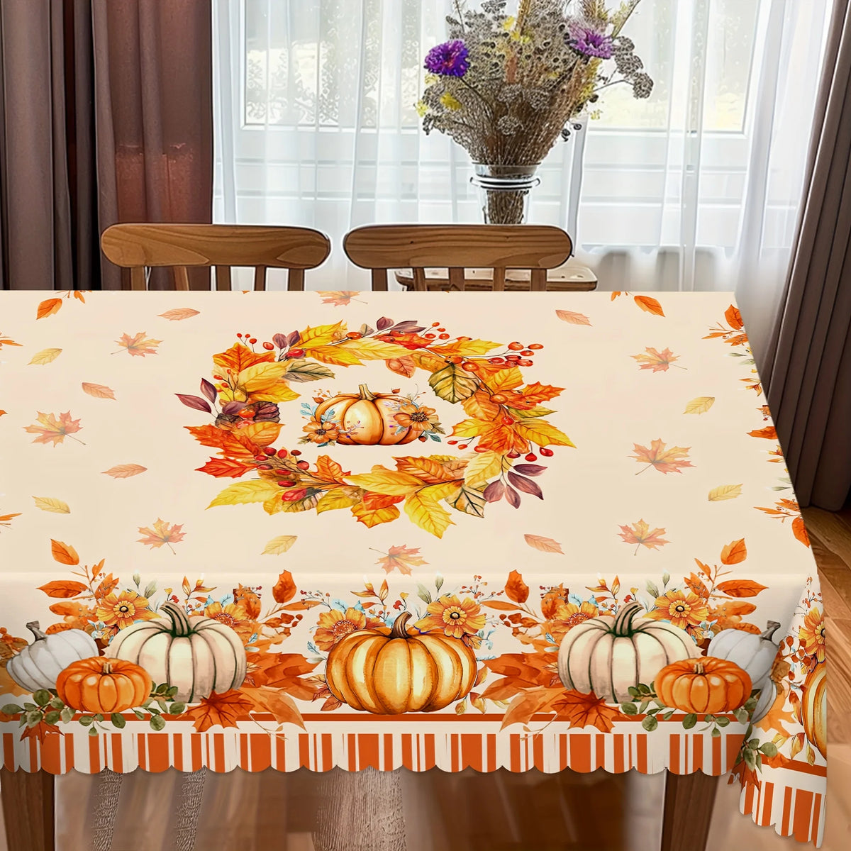 Fall harvest tablecloth featuring orange pumpkins, maple leaves, and autumn foliage on a beige background.