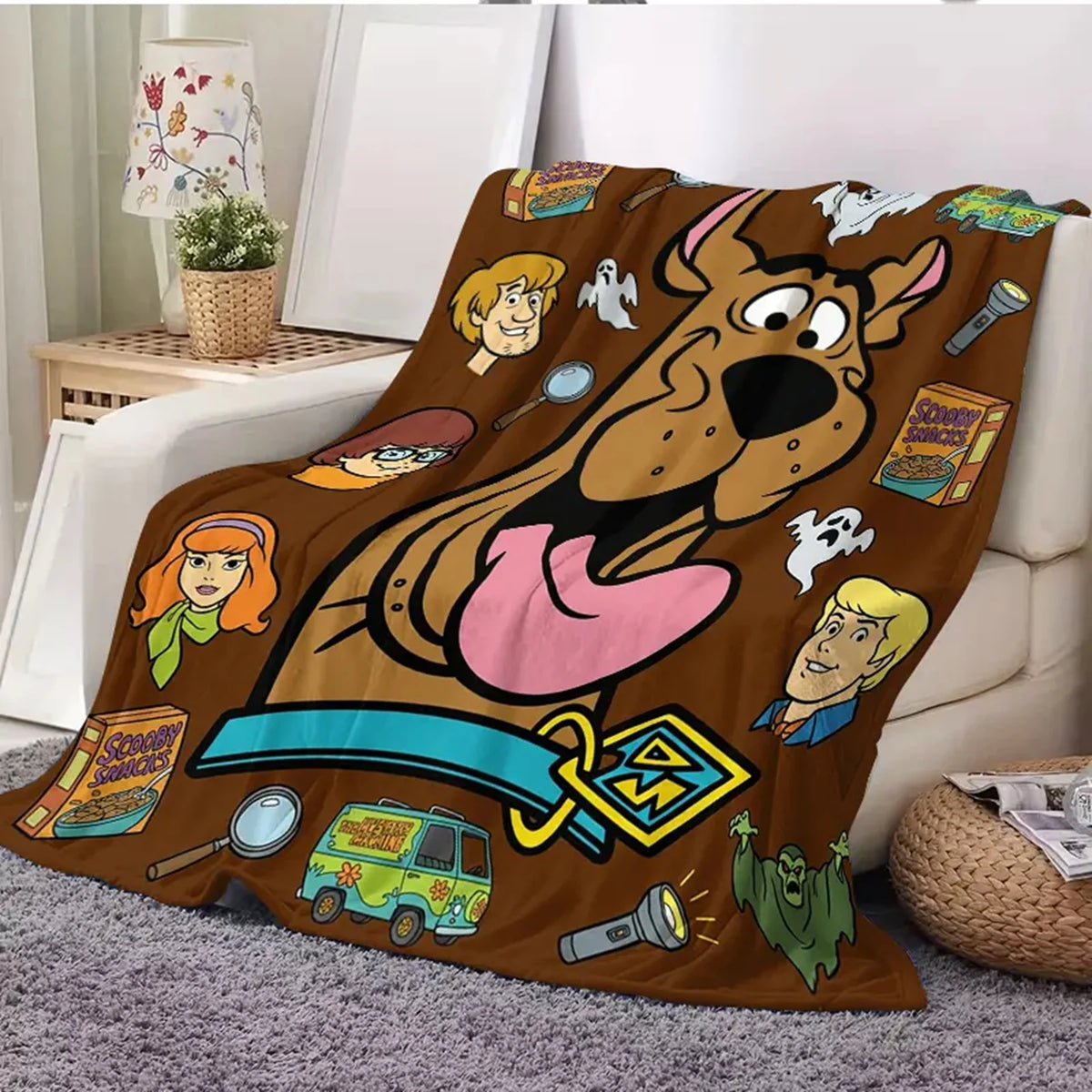 A brown cartoon dog design printed on a flannel throw blanket with various character illustrations.