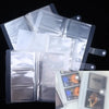 A transparent photo storage card album with multiple clear plastic sleeves and a dark gray cover.