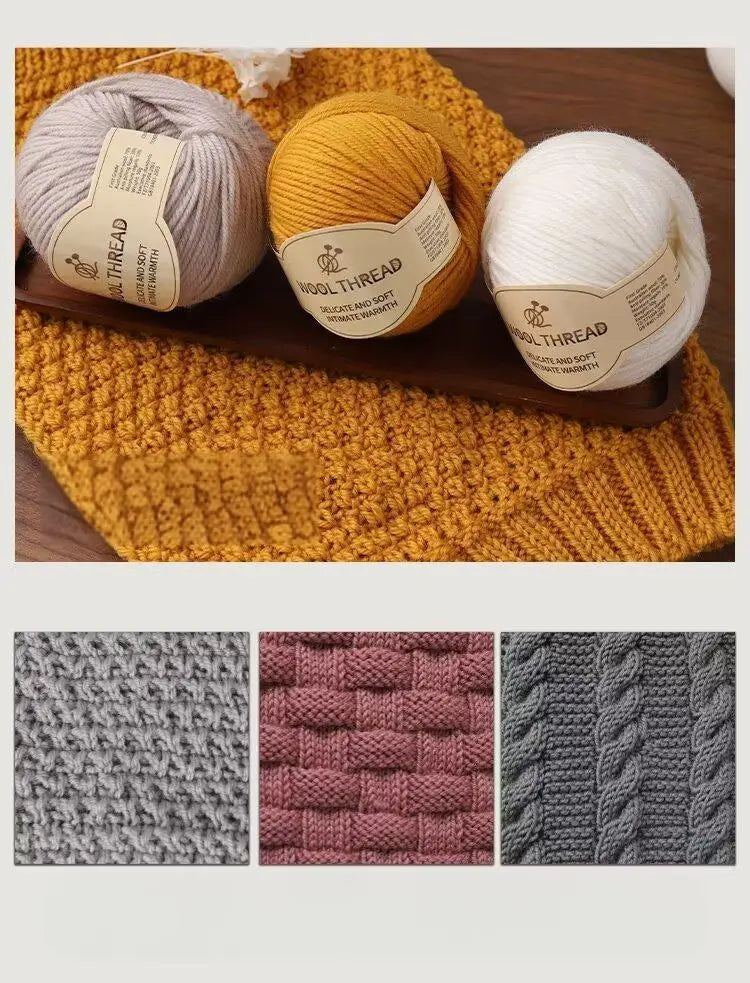 Three balls of wool thread in beige, yellow, and white are displayed on a wooden board.