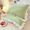 A set of ruffled princess pillowcases in light green and white with a hidden zipper.