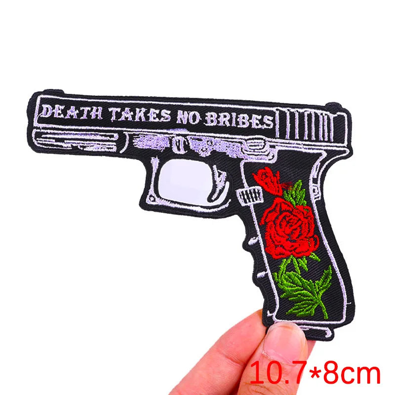Black embroidery patch depicting a rose and skull design with the text Death Takes No Ribes