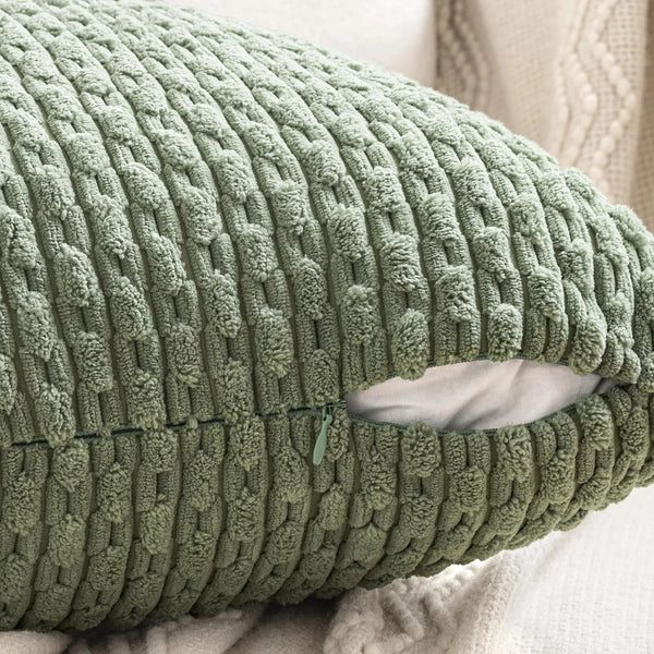 A close-up of a textured, olive green corduroy throw pillow cover.