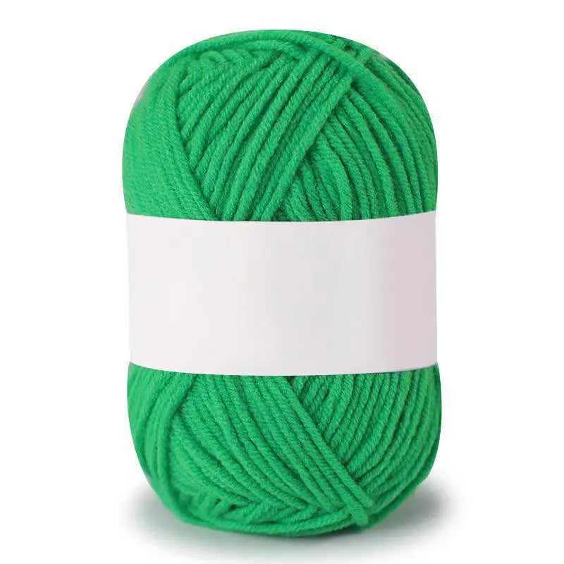 A ball of bright green soft milk cotton knitting yarn.