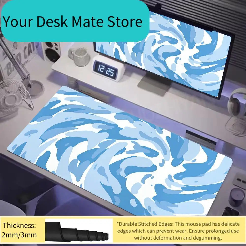 A blue and white swirling vortex mouse pad displayed on a desk next to a computer monitor.