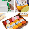 A collection of yellow and pink milk cotton yarn skeins for knitting and crochet projects.