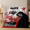 A red and white horror themed flannel throw blanket featuring distressed handprints and skull imagery