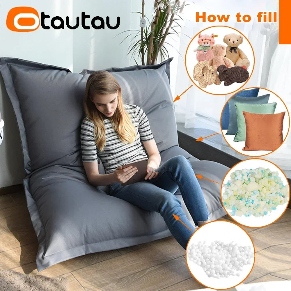 A woman is sitting on a gray outdoor bean bag cover, demonstrating how to fill the product with foam pellets.