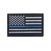 A black flag patch featuring the design of the American flag with white stars and horizontal stripes.