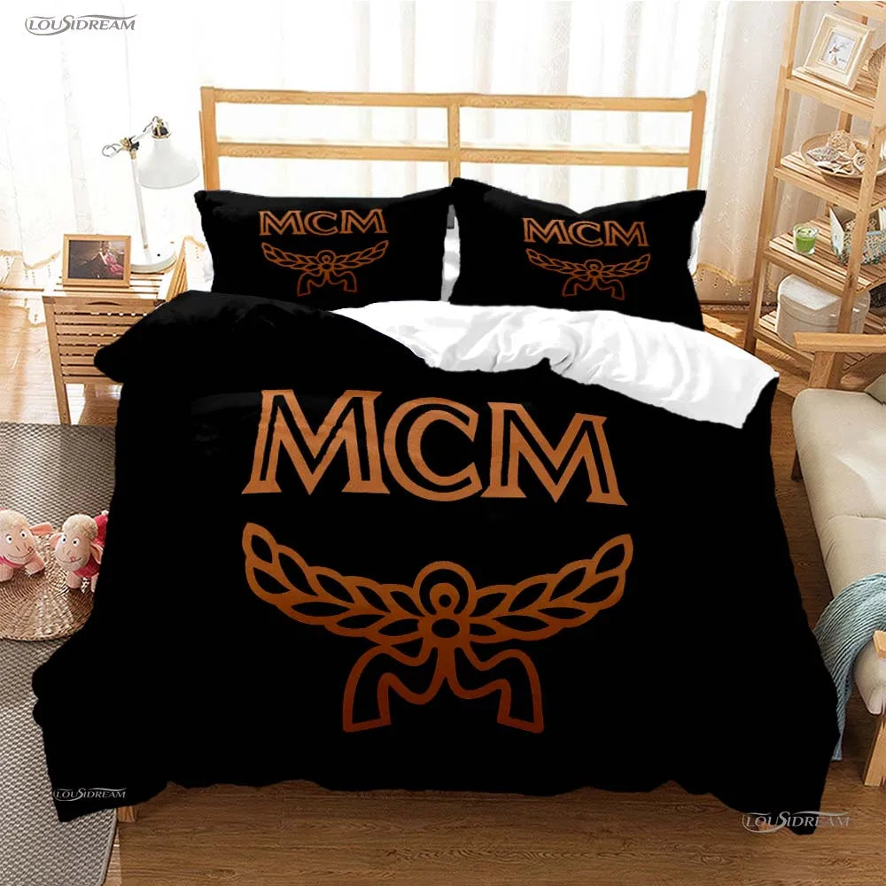 Black duvet cover featuring a large gold MCM logo design on a bed.