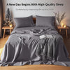 A gray French stone washed linen bedding set featuring pillows and a duvet on a bed.