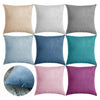 A collection of soft velvet decorative pillow covers in various shades of gray, blue, and mauve.