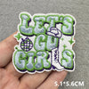 Embroidered patch featuring the slogan 'LETS US GIRLS' in green and gray thread on a light background.