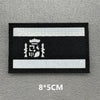 Black and white reflective patch with an emblem on a gray background