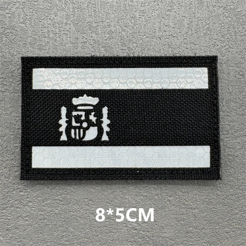 Black and white reflective patch with an emblem on a gray background
