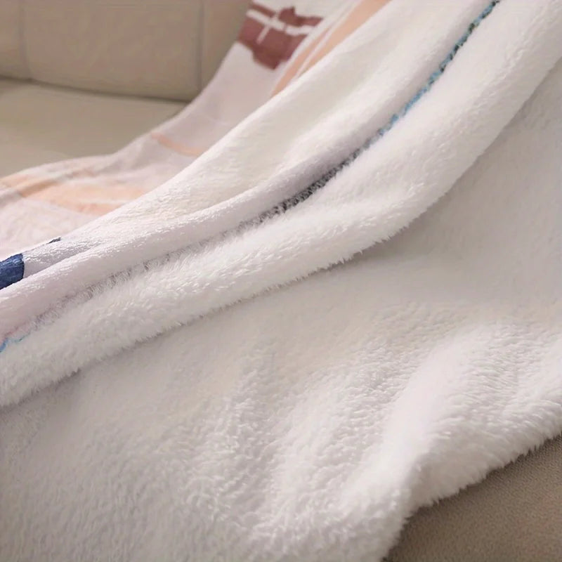 A close-up of a white faux fur throw blanket with subtle colored stripes and a decorative trim.