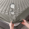 A fitted sheet with a quilted texture and clear plastic bubbles is being shown on a mattress.