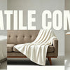 A beige flannel blanket draped over a sofa and a white duvet on a bed.