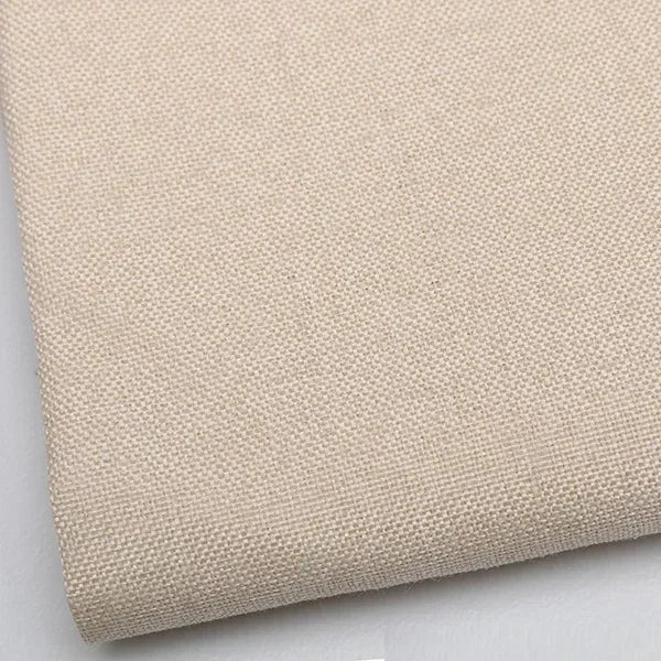 Close-up of beige coarse linen and cotton fabric texture rolled up for DIY projects
