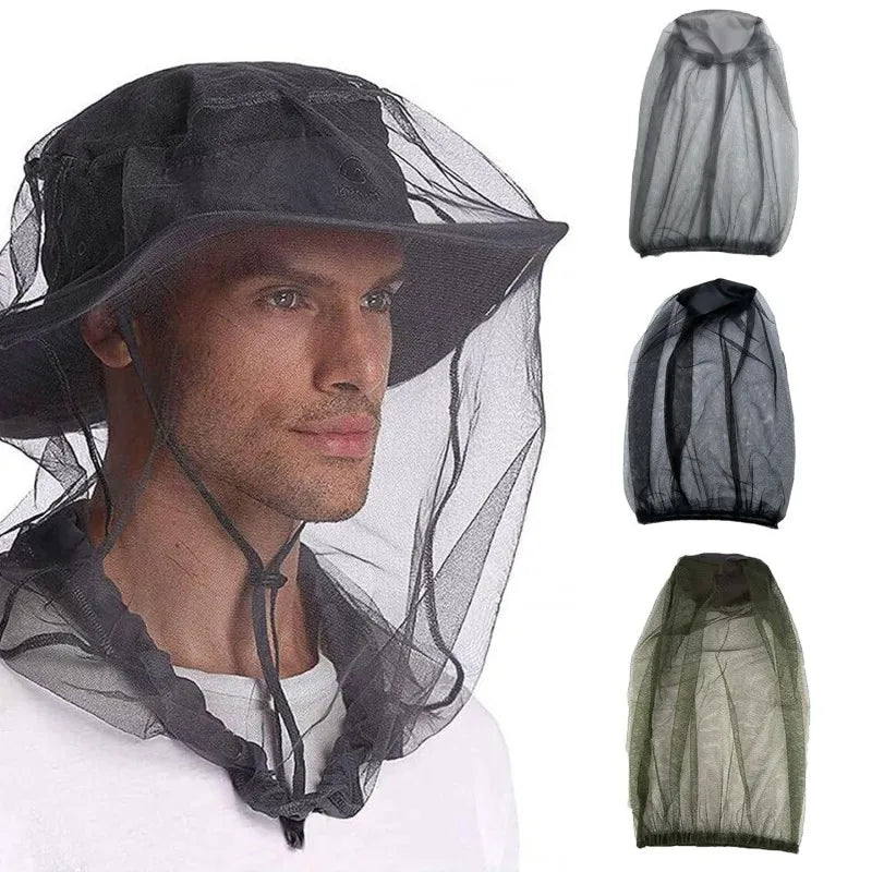 A man wearing a black mosquito protection fishing hat with a sheer mesh veil.