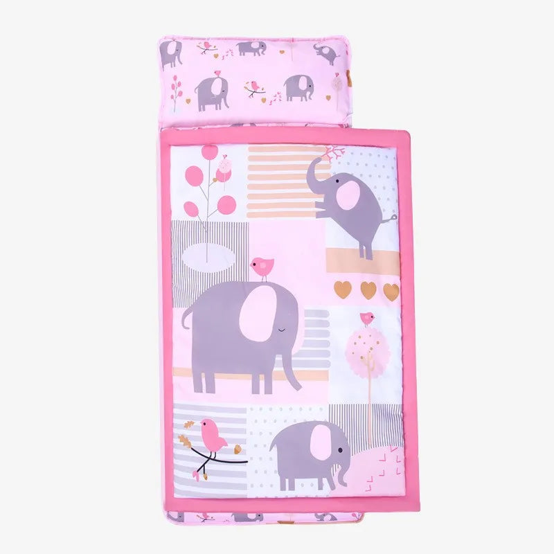 A pink toddler nap mat set featuring a pillow and a fleece blanket with elephant and bird patterns.