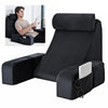 Black ergonomic back support pillow with armrests shown in a seated position.