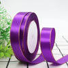 Rolls of purple satin ribbon with gold edges for gift wrapping and crafts
