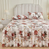 A floral ruffle bed skirt set featuring red and pink roses on a white background.