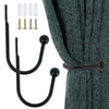 A set of black metal curtain holdback hooks and corresponding screws shown next to a teal curtain.