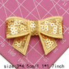 A beige sequin bow patch is shown on a pink grid background, measuring 3x4 cm or 1.1x1.7 inches.