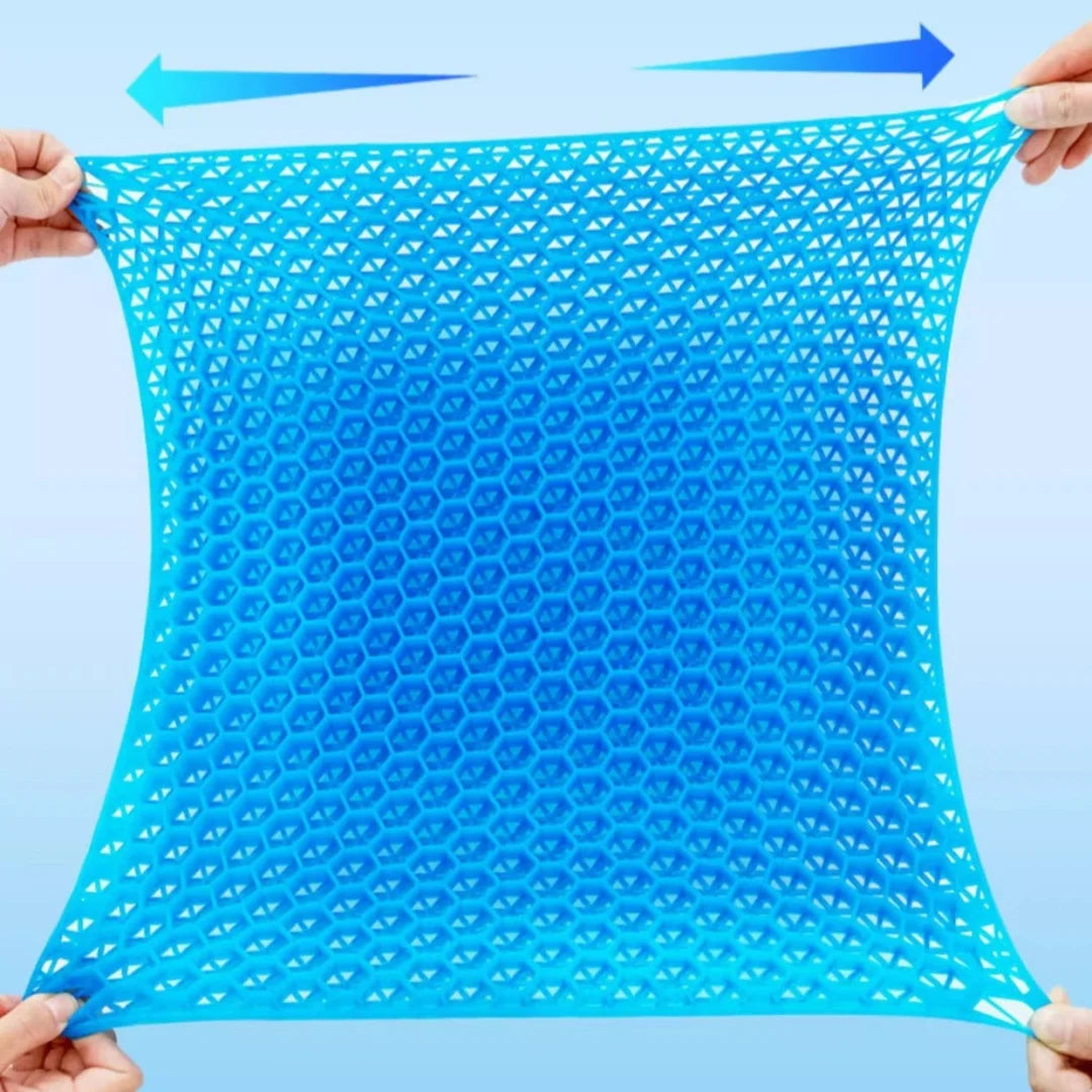 A bright blue honeycomb silicone seat cushion being held by hands, showing its mesh texture.
