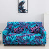 A vibrant teal and purple floral patterned stretch fabric sofa cover displayed on a white floor.