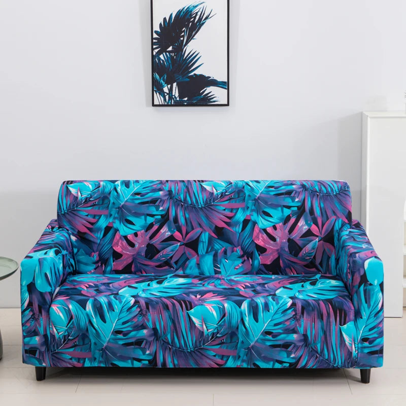 A vibrant teal and purple floral patterned stretch fabric sofa cover displayed on a white floor.