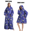 A purple adult-long plush fleece blanket hoodie with a hood and embroidered animals is shown on a model.