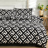 Black and white geometric marble print duvet cover set with pillows on a bed.