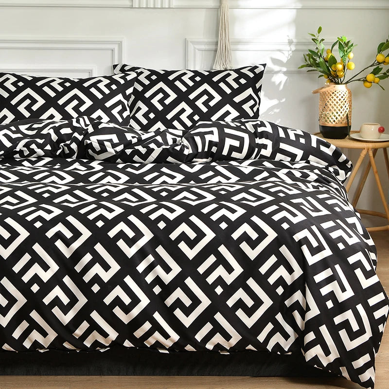 Black and white geometric marble print duvet cover set with pillows on a bed.