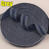 Roll of grey iron-on hem tape for pants and jeans