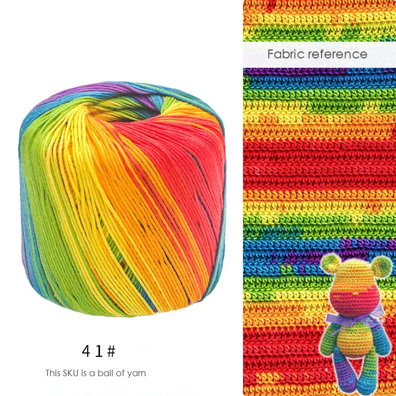 A ball of hand knitting yarn showing a vibrant gradient of rainbow colors.