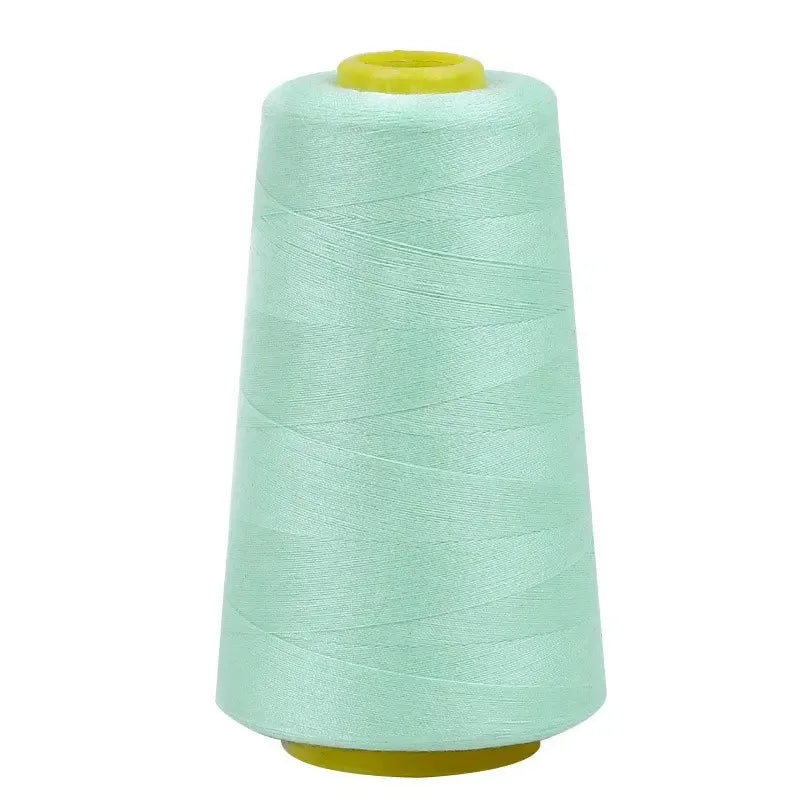 A roll of light mint green sewing thread on a spool.