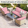 Pink outdoor sofa cushion covers protecting wicker sofas in a garden setting.
