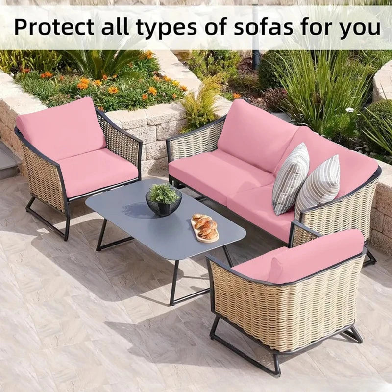 Pink outdoor sofa cushion covers protecting wicker sofas in a garden setting.