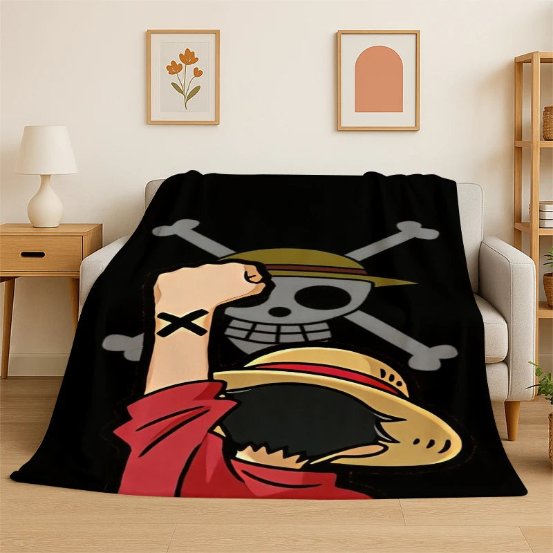 A black blanket featuring an anime character design with a skull and crossbones motif.