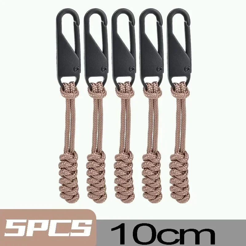 Four black detachable zipper pull sliders with braided cord attached, 10cm long.