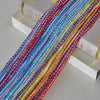 A close-up of colorful decorative door string curtains bundled together on a white surface.