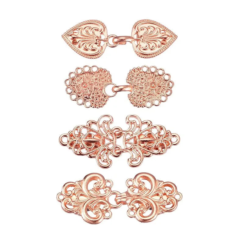 A set of vintage rose gold zinc alloy sweater clips featuring intricate floral designs.
